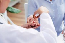 hands-unrecognizable-female-doctor-giving-pills-patient-scaled.jpg